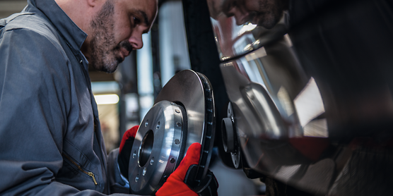 TRW mechanics working with part.