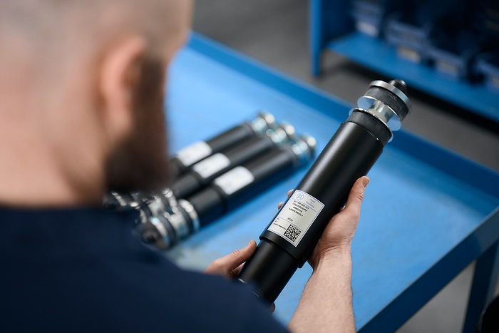 employee inspects damper item 