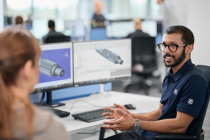 employee explains the technical drawing