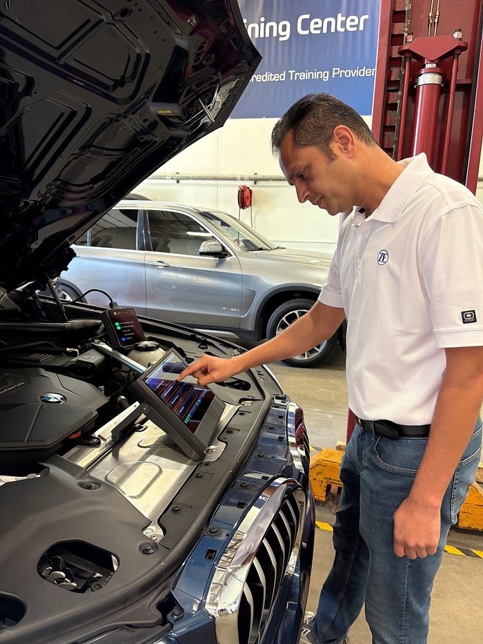 Man in pc workshop with diagnostic tool