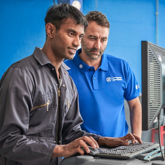 two male colleagues wotking at a computer