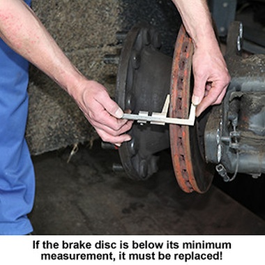 employee measuring the brake disc